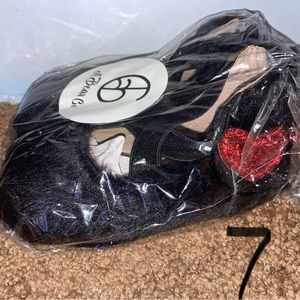 Size 7 furry black (with red heart) ballerinas. New in bag.
